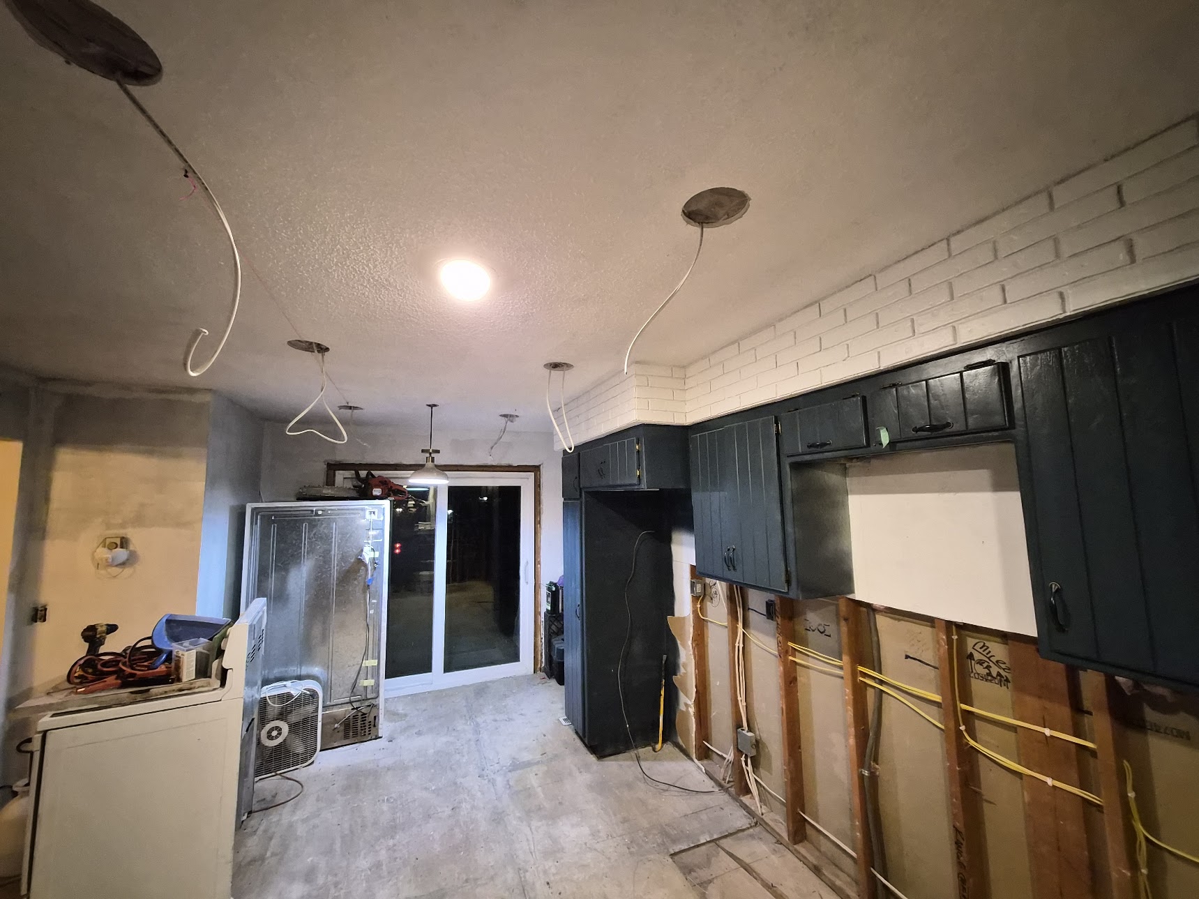 Kitchen renovation with ceiling openings and cable runs for recessed lighting
