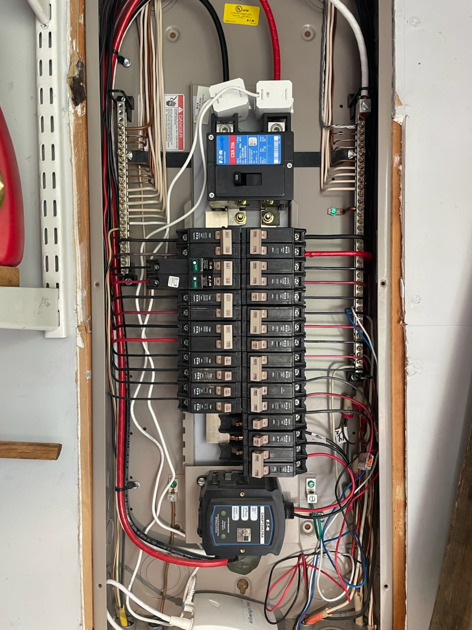Electrical panel interior showing breakers, conductors and wire routing