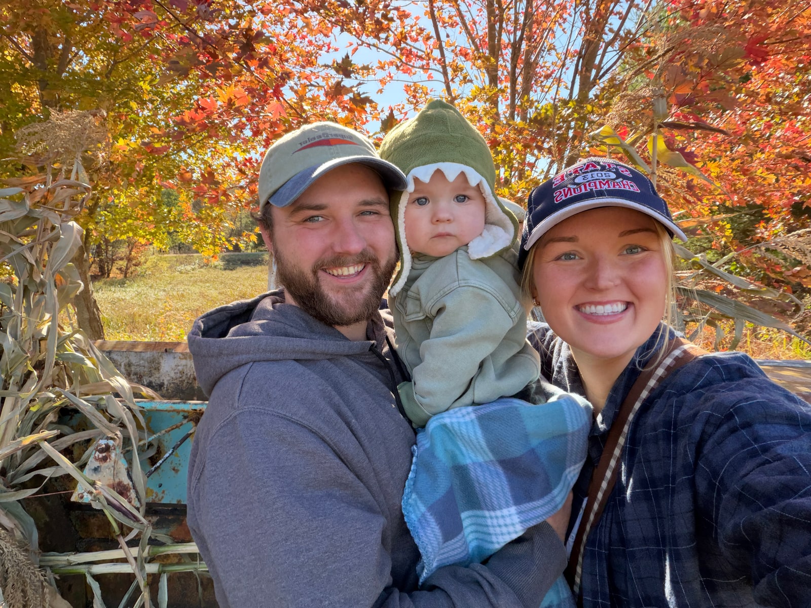 Reece Poppie holding his son in an outdoor group photo